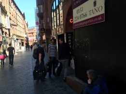 Musicians heading into the Cavern Club. Mathews Street in the background.